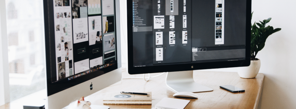 Designer arranging a homepage wireframe template on a laptop, with hero, benefits, proof, and CTA blocks.