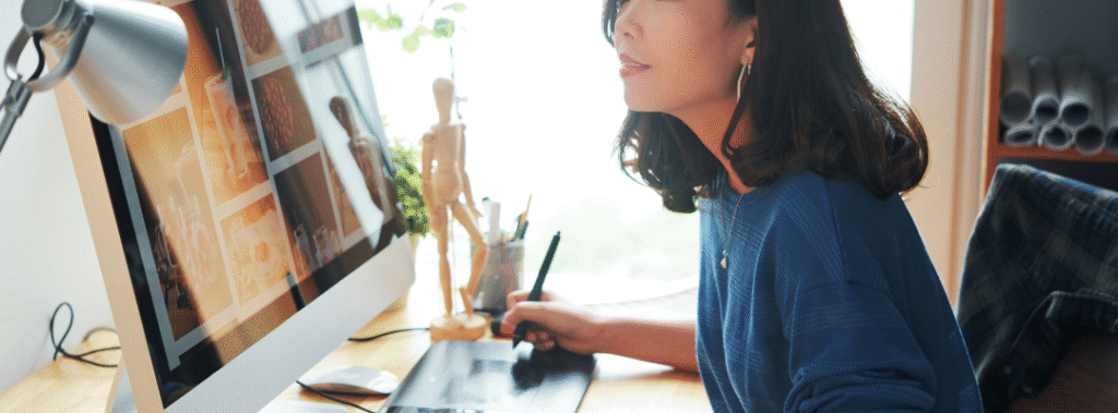 A designer comparing a layout mockup and code on a laptop, visual for web design vs web development.