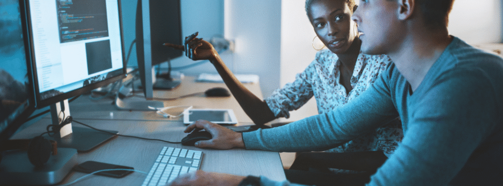 Web designers work on website development, paying attention to with a clear hero, trust badges, and a visible call to action.