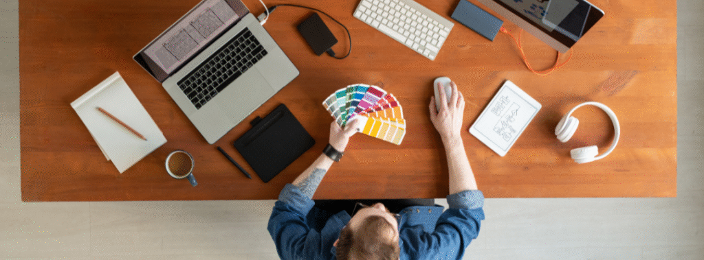 Overhead view of a designer creating a cohesive visual identity system that supports Sacramento branding and improves brand consistency.