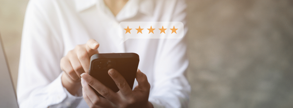 A customer leaving a review for a local business on their cellphone, showing how important it is to leverage customer reviews.