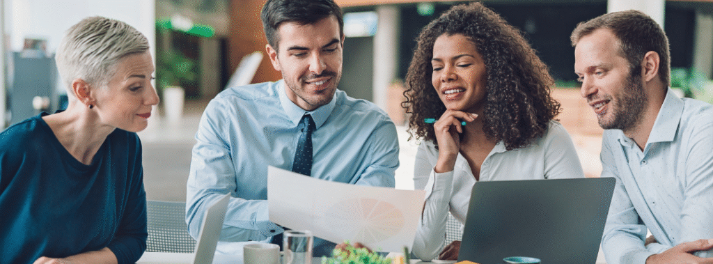 A group of business owners work on reviewing their campaigns to measure marketing ROI.